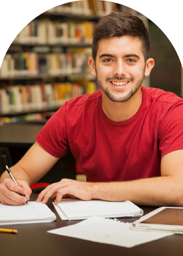 Young male student writing notes in a library, symbolizing postgraduate studies in nutrition and dietetics, academic growth, and professional development in health and wellness education.